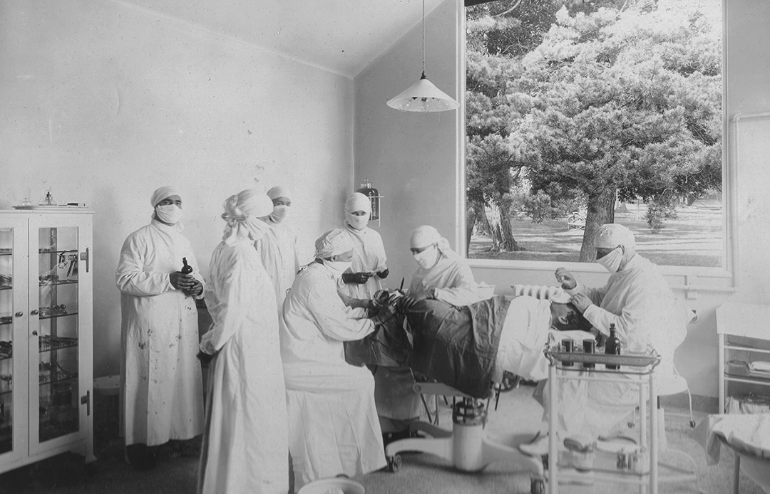 Nurses and doctors operate on a patient